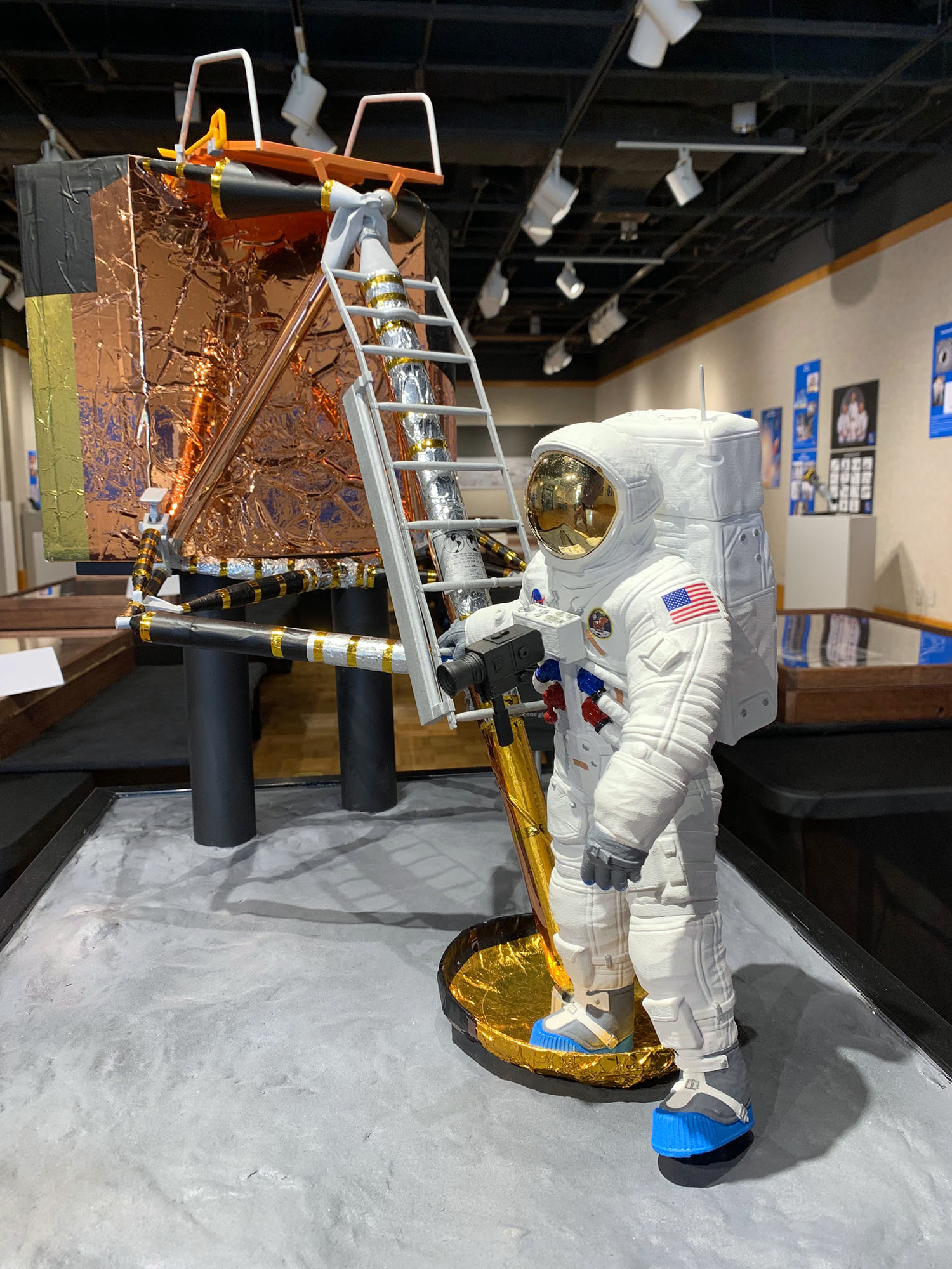 diorama of Astronaut holding onto a ladder