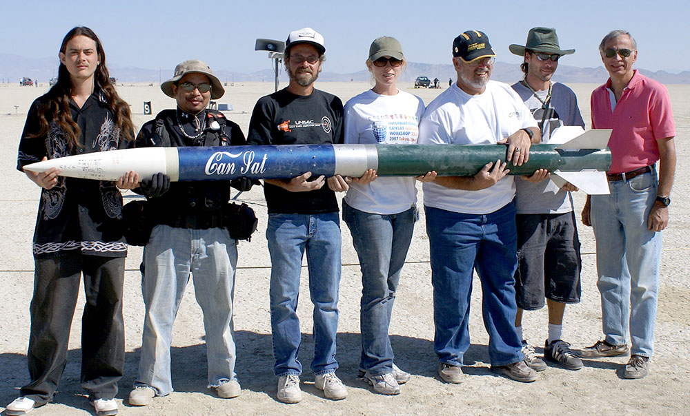 ARLISS team holding and showing off their rocket